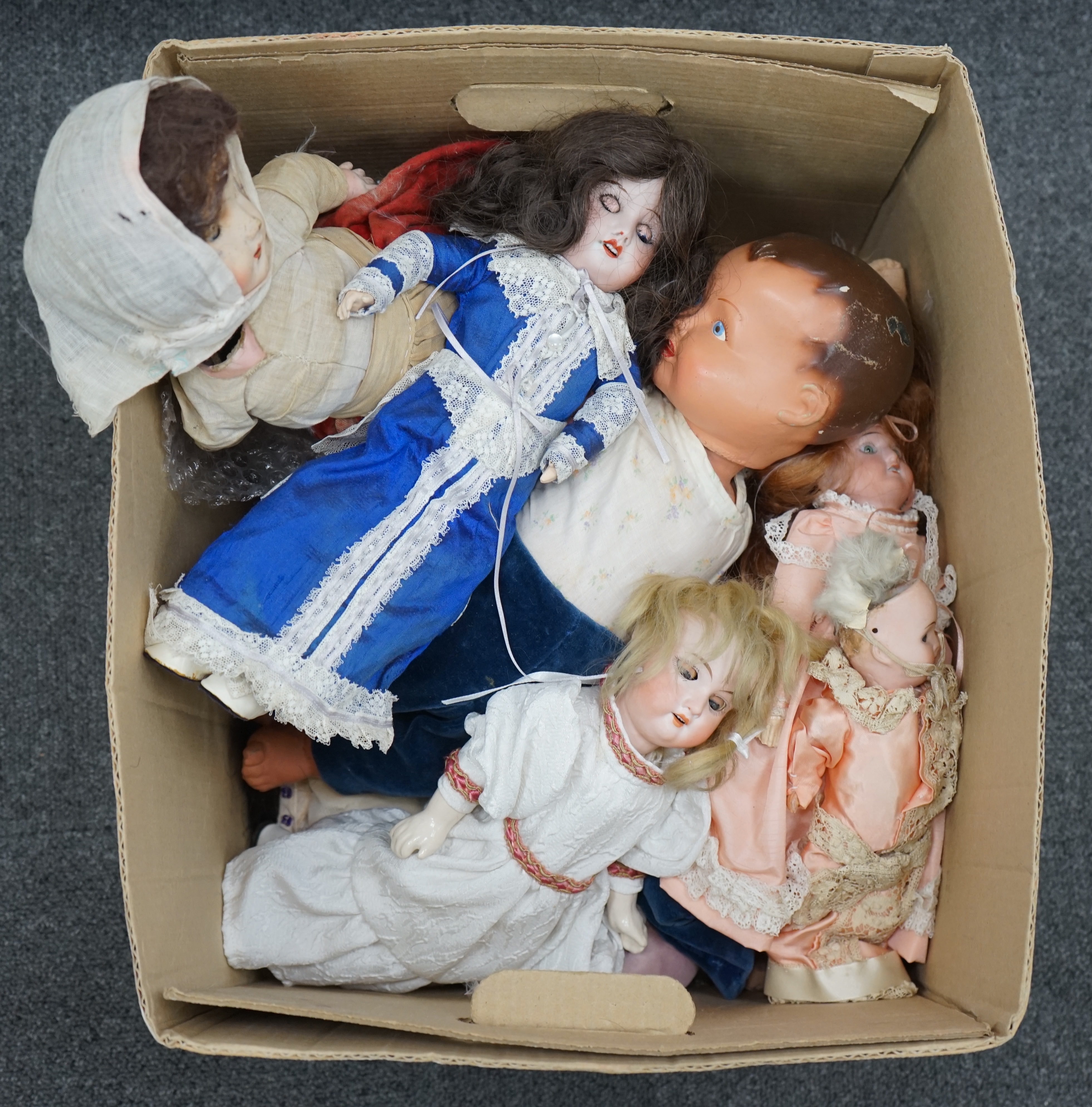 An Armand Marseille bisque doll, mould 390, a small Hermann Steiner bisque doll, three other bisque dolls including an SFBJ 60, and four composition dolls, Armand Marseille 33cm. Condition - poor to fair